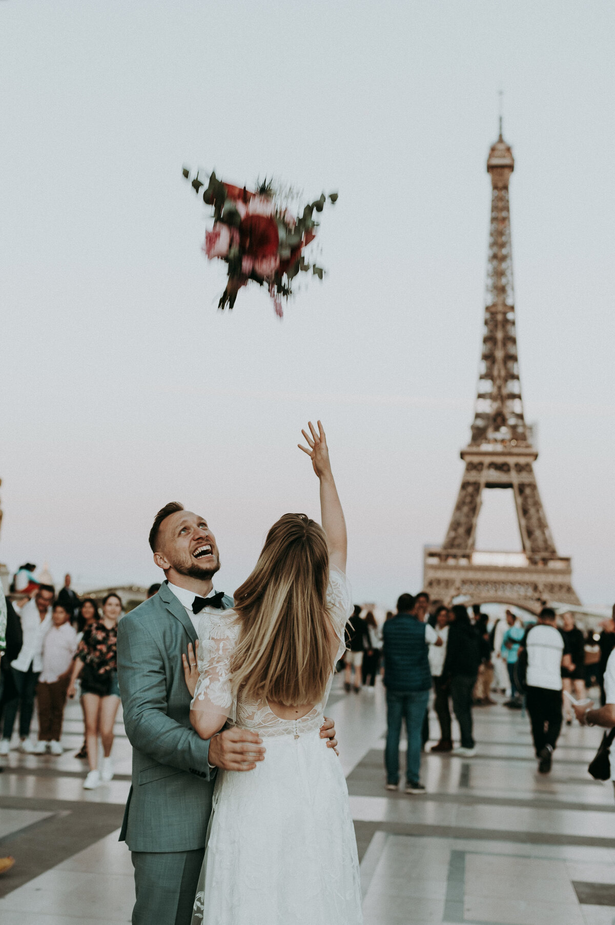 Bruidspaar wandelt voor Eiffeltoren.