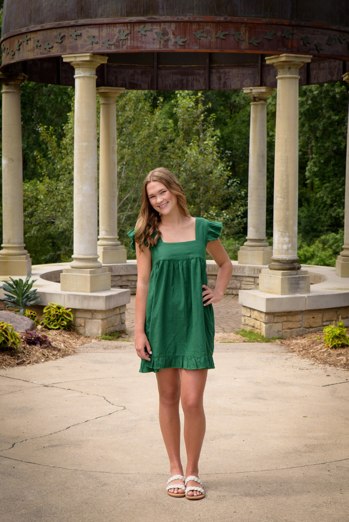 Luxemburg Casco High School senior girl wearing short kelly green dress in the flower gardens at the Green Bay Botanical Gardens in Green Bay, Wisconsin