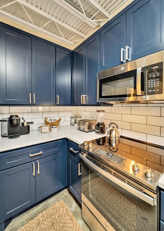 Fully stocked kitchen with Keurig coffee bar in this 2 bedroom, 2.5 bathroom luxury vacation rental loft condo for 8 guests with incredible downtown views, free parking, free wifi and professional decor in downtown Waco, TX.