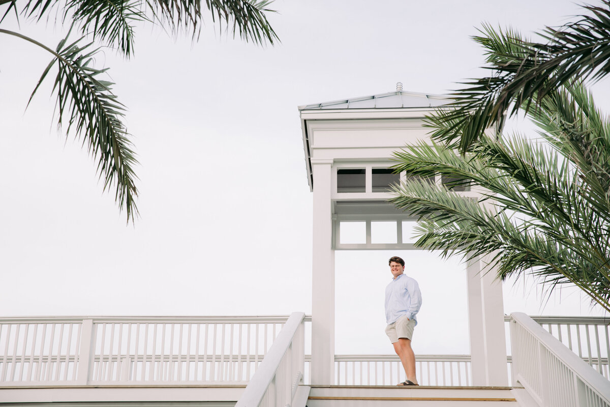 A boy standing at the top of a staircase