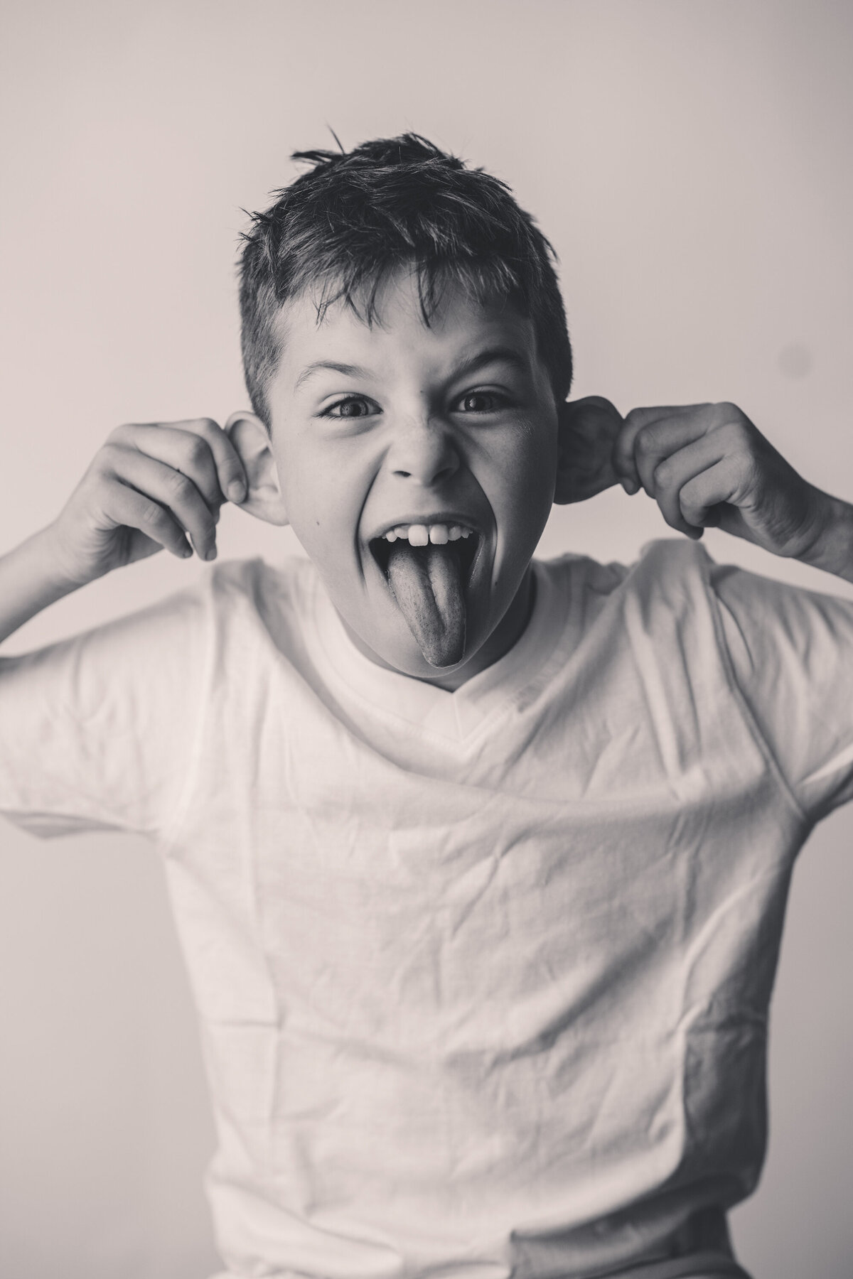 Young boy playfully poses for Personality Portraits in Charleston, South Carolina.