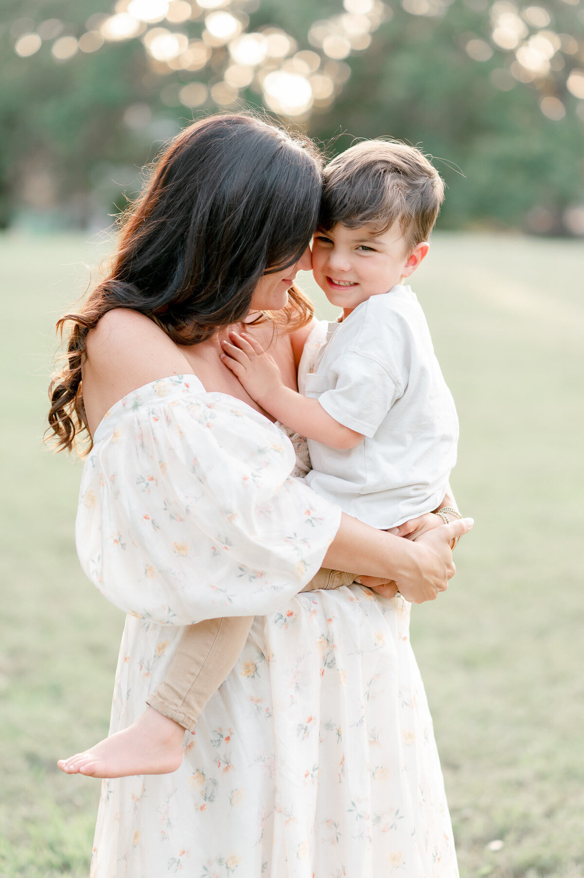 A mother hugs her toddler son