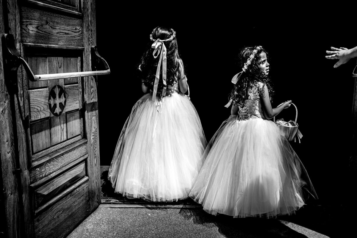 Flower girls wait to enter a church at a Chicago wedding.