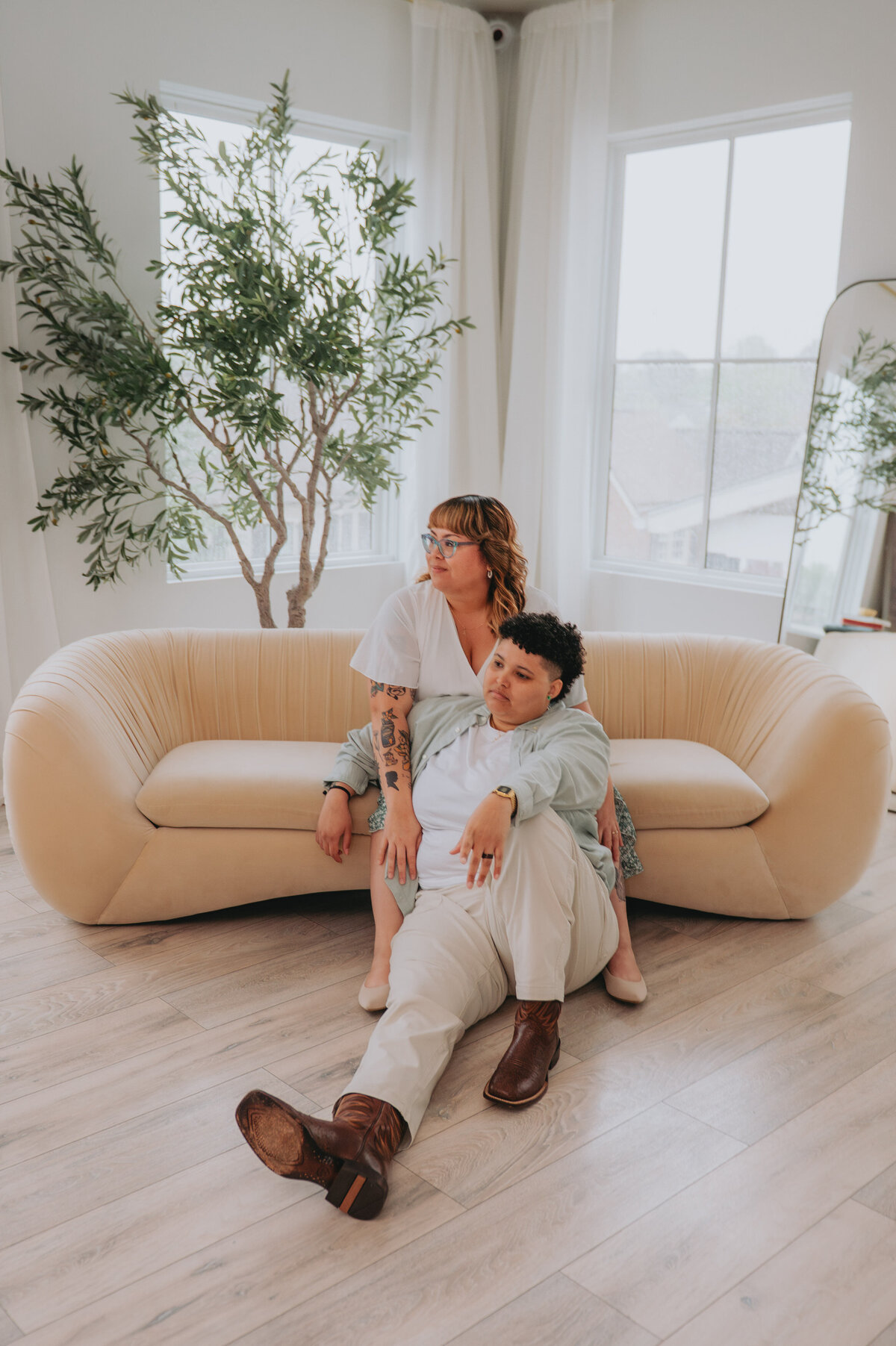 A couple poses on a couch