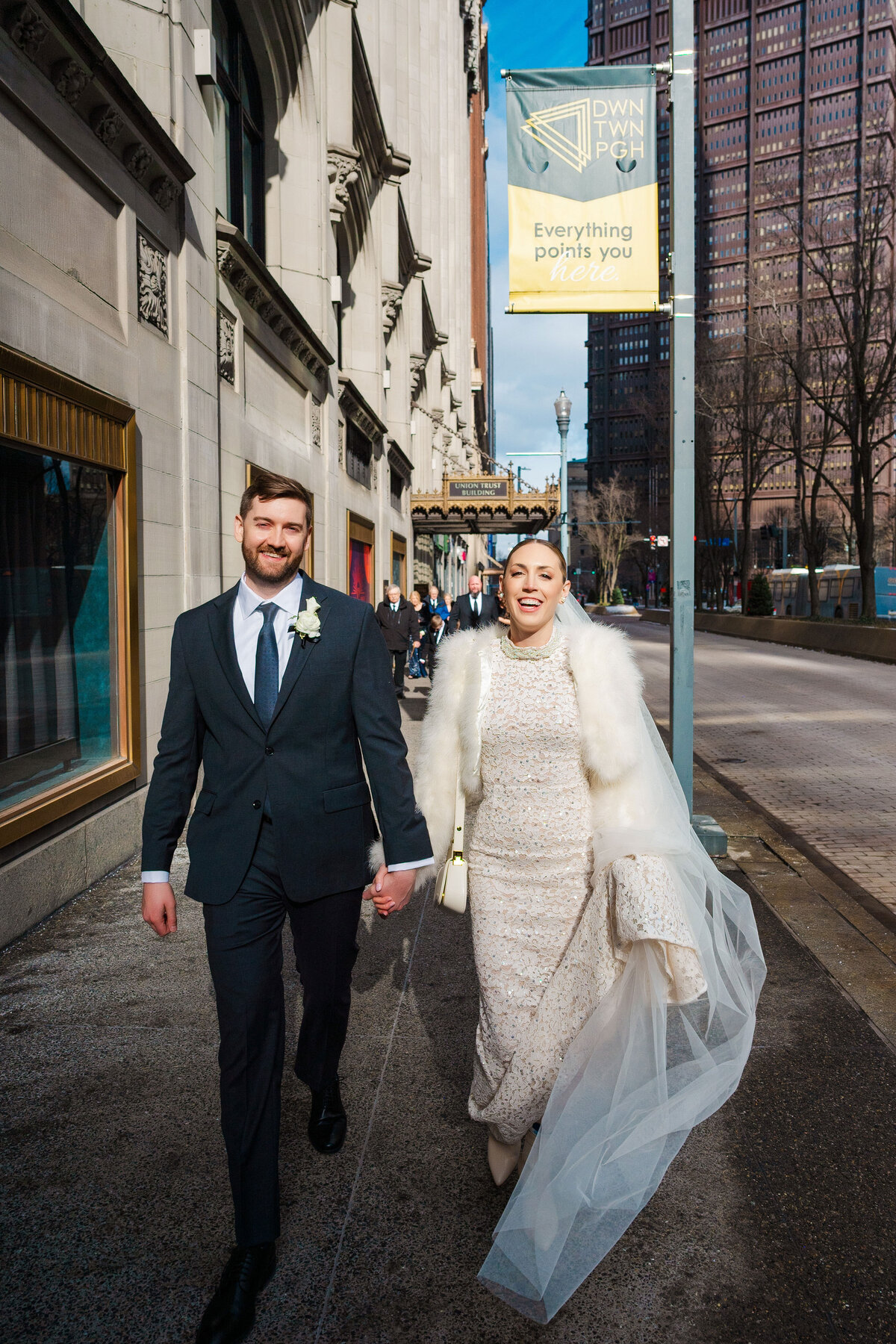 couple walking to their wedding on the downtown pittsburgh street