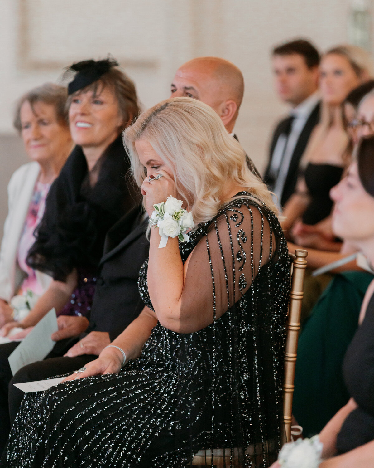 Emotional moment as mother of the bride tears up during ceremony, Philadelphia wedding photographer shot.