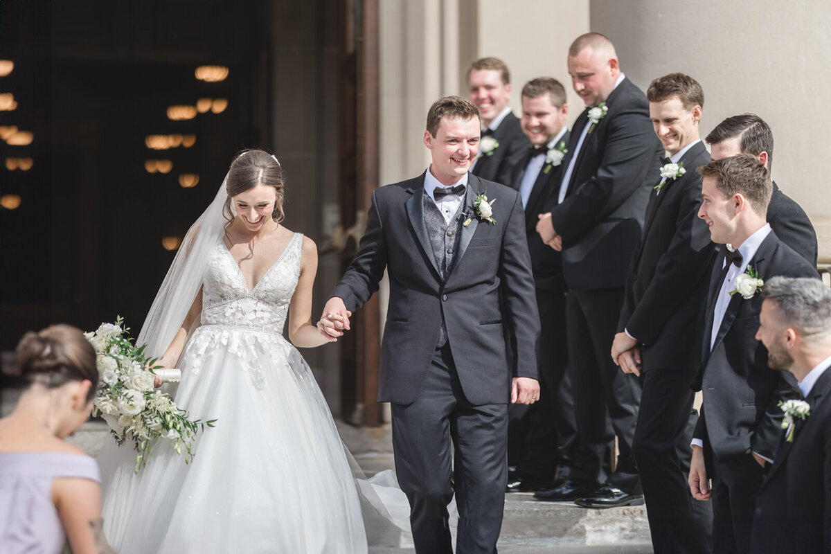 A bride and groom leaving the church  after their ceremony