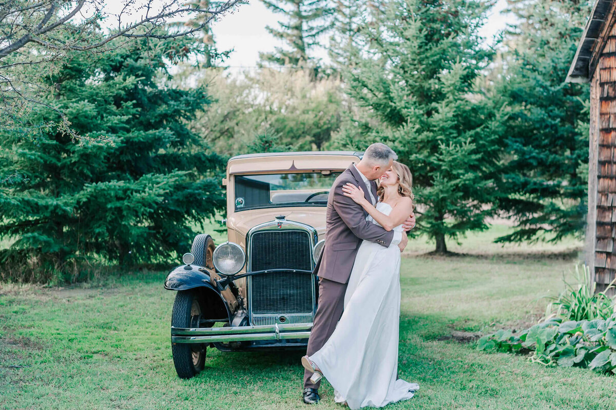 Groom dips his bride and goes in for a kiss.
