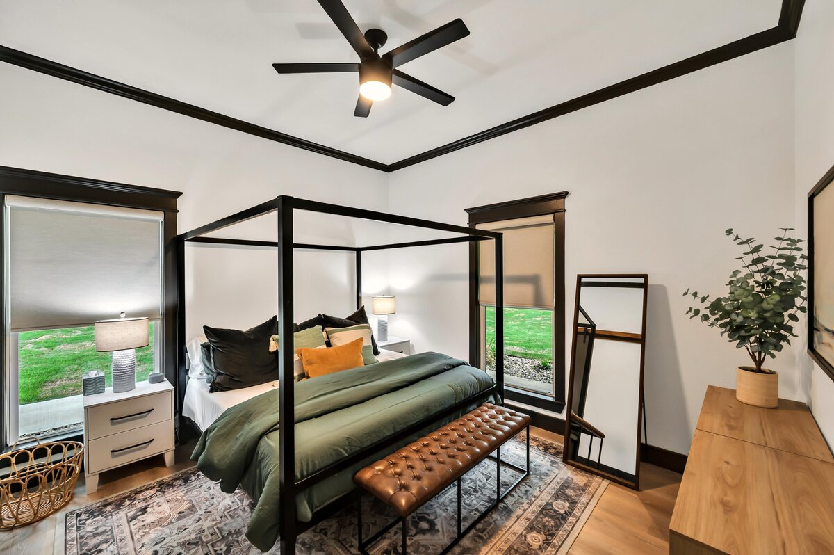 Beautiful bedroom with luxurious bedding and full length mirror in this three-bedroom, three-bathroom vacation rental home with free wifi, outdoor theater, hot tub, propane grill and private yard in Waco, TX.