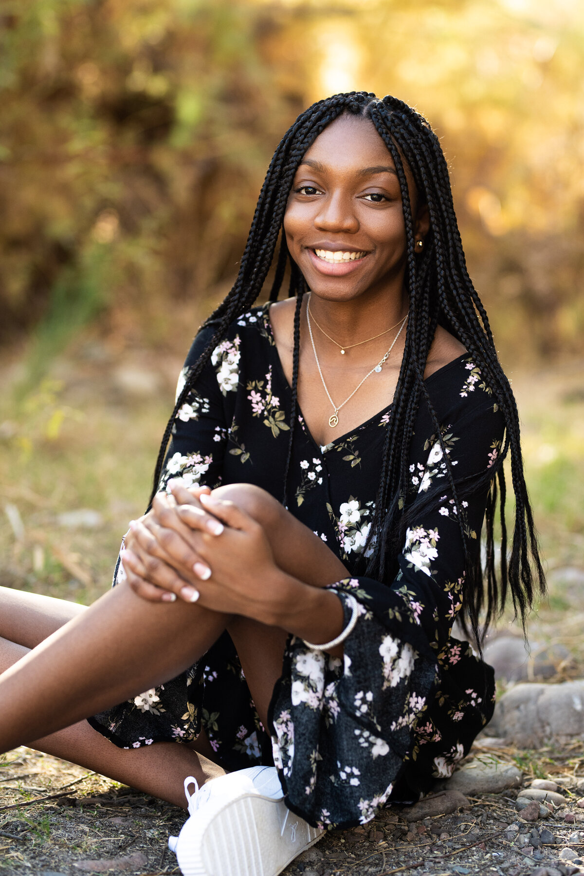 Black senior girl sitting  on the ground