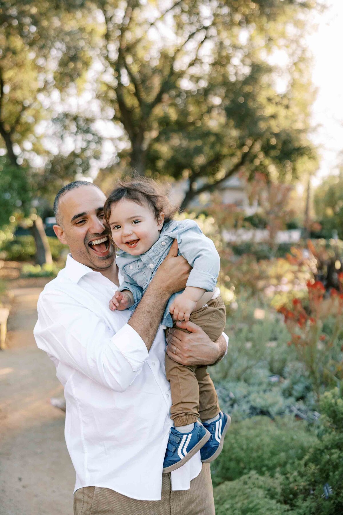dad and son playing and smiling