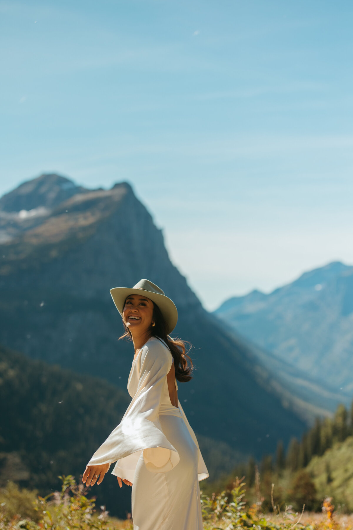 bride laughs in mountain valley