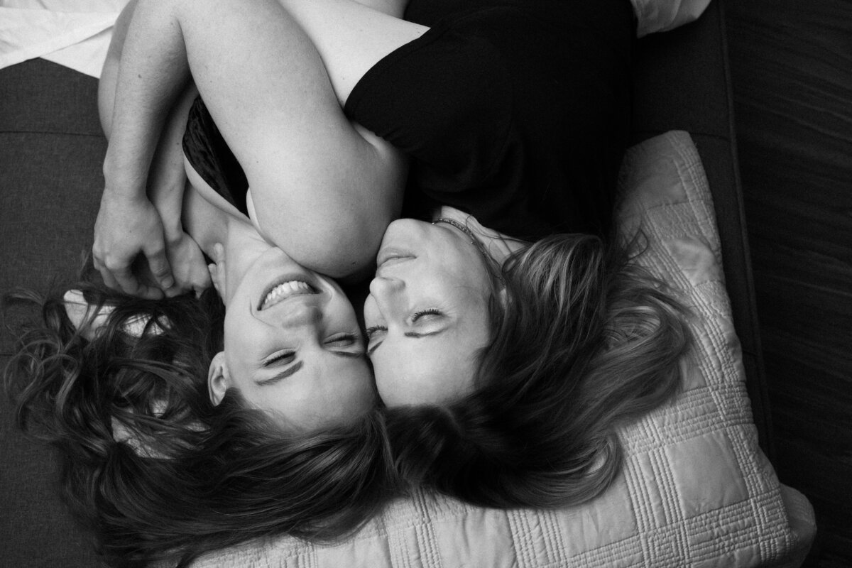 Two women cuddling and a cute, loving couples boudoir image.