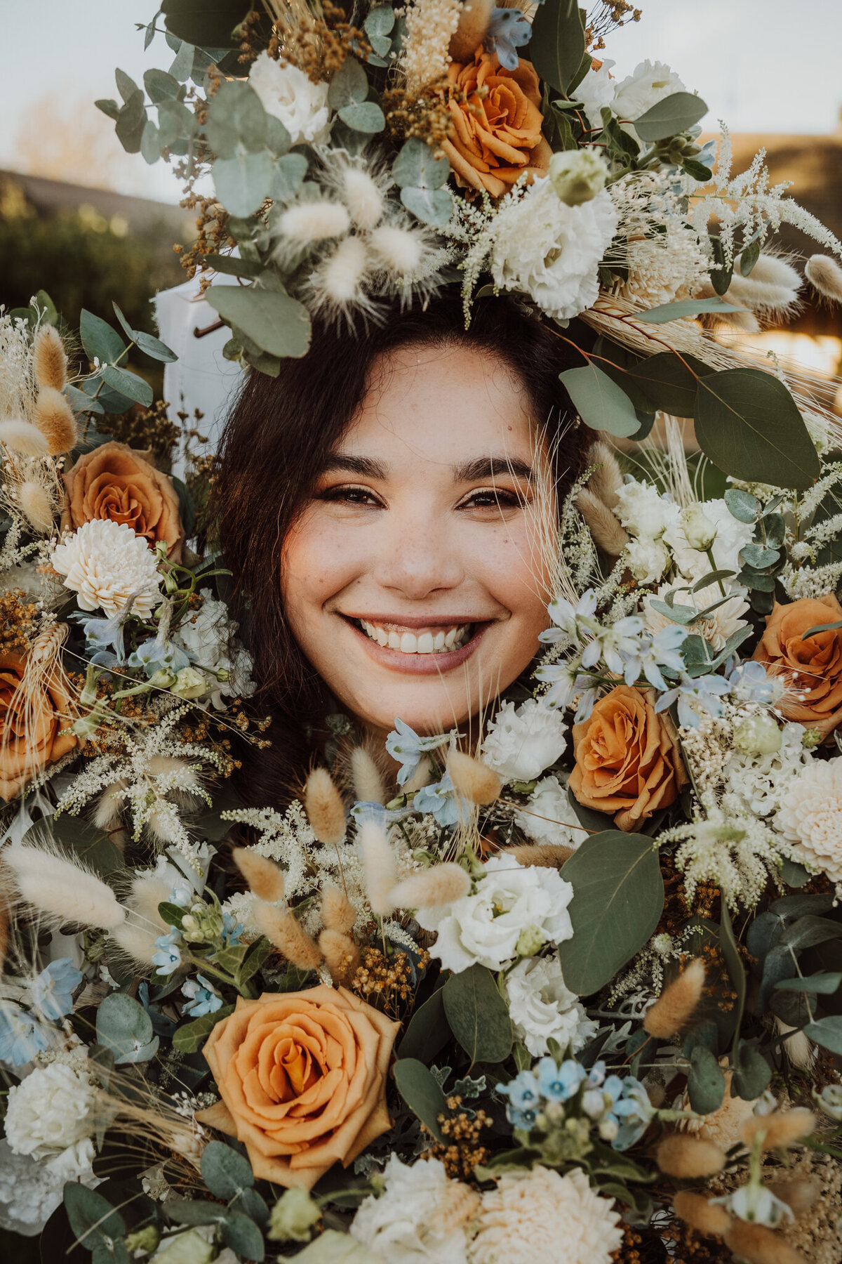 Bridesmaid framed with bridesmaids bouquets