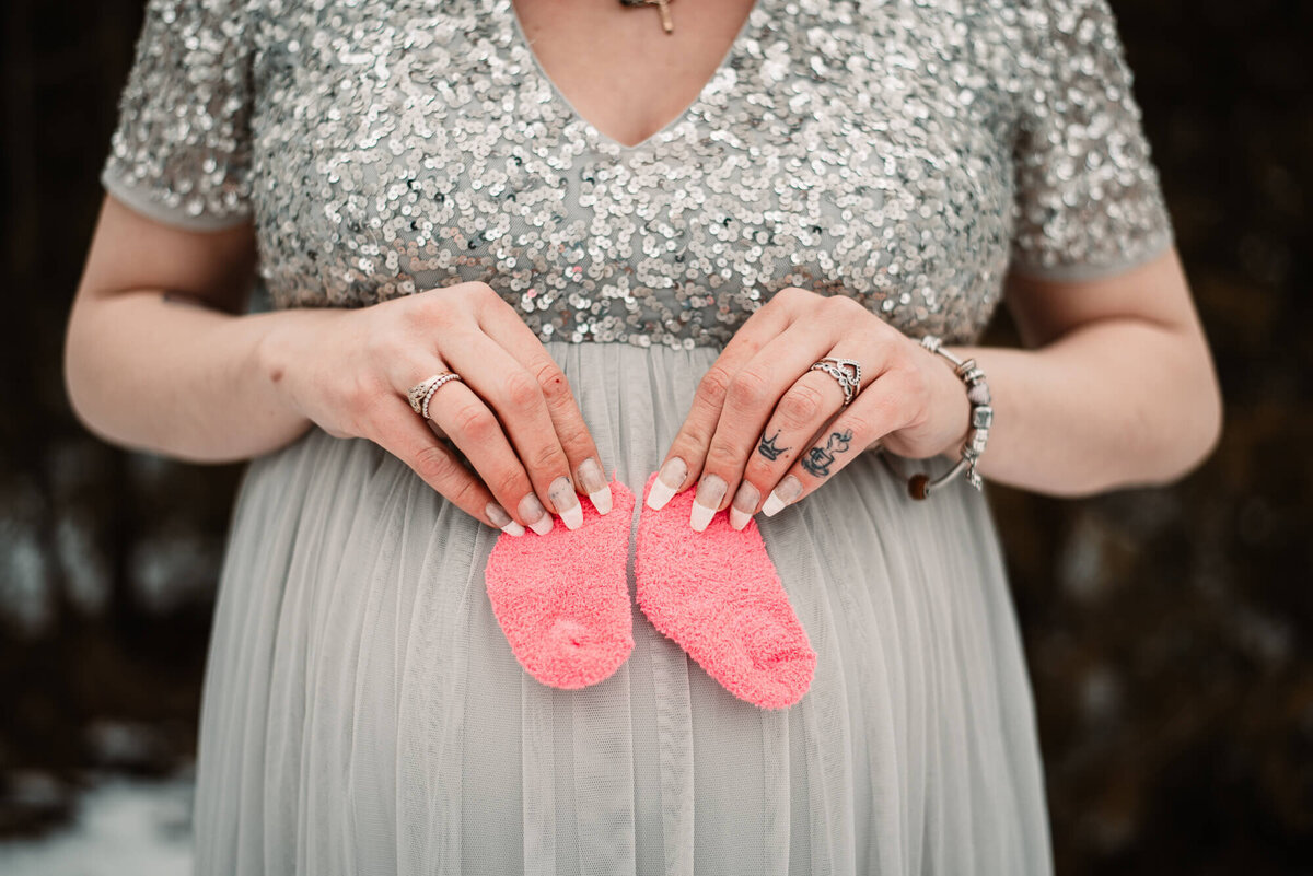 Pregnant mother with baby socks in Toronto Maternity photo