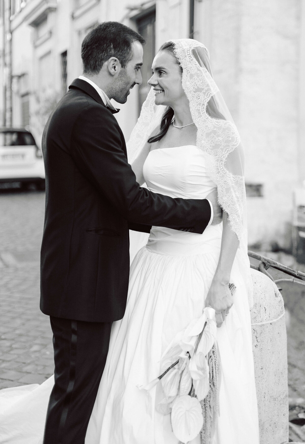 Newlyweds walking along Roman street after ceremony

