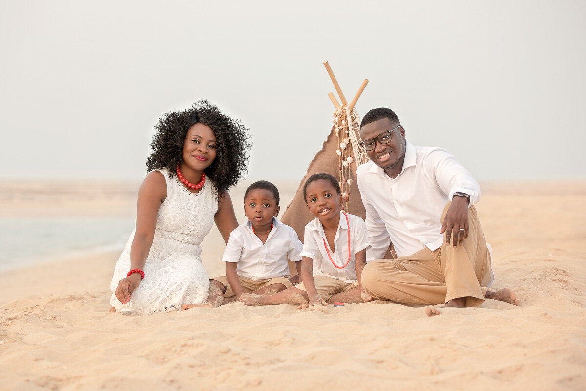african-family-sitting-on-the-beach