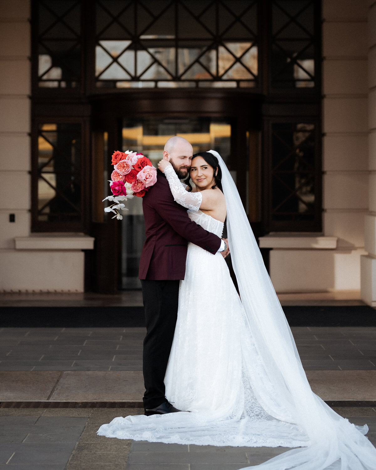 Bride and groom kissing under the sunset at their wedding, frozen forever by JakeyVass Media.