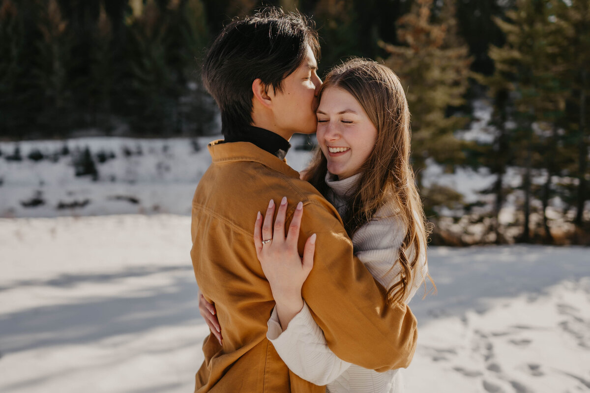 Edmonton engaged couple hugging during a winter sunset