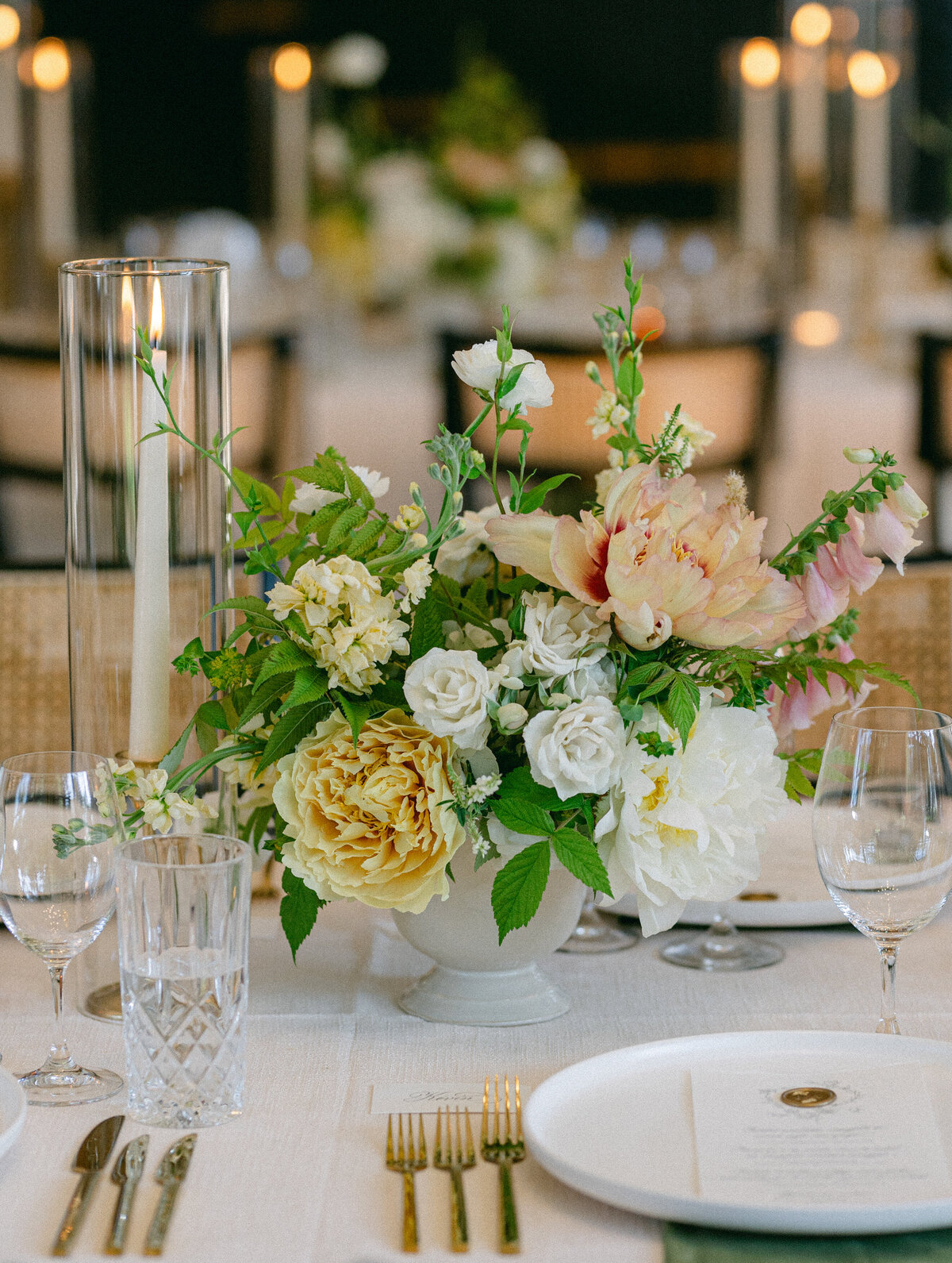 A lush centrepiece of spring flowers decorates a table at a wedding reception at La Toundra.