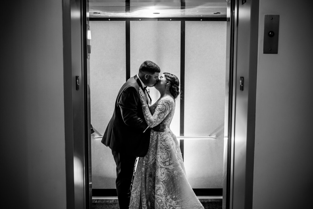 bride and groom kidding in elevator