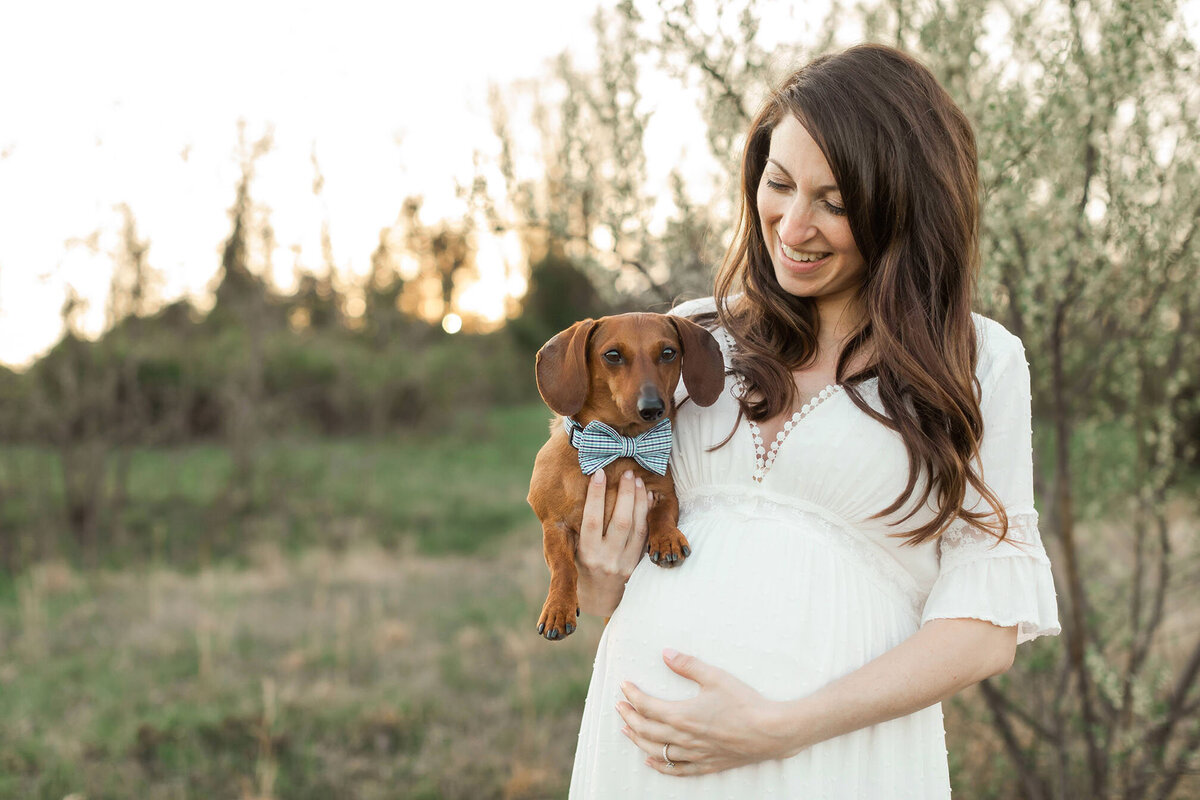Outdoor DC maternity session with pregnant woman holding her dog