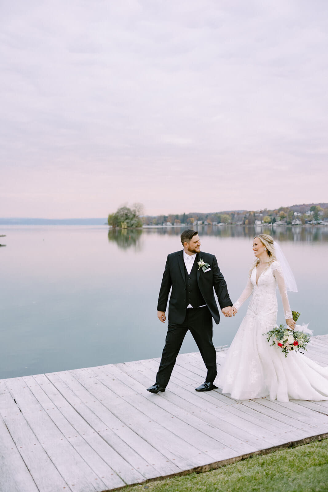 Bride and groom walking along path at The Lake House on Canandaigua