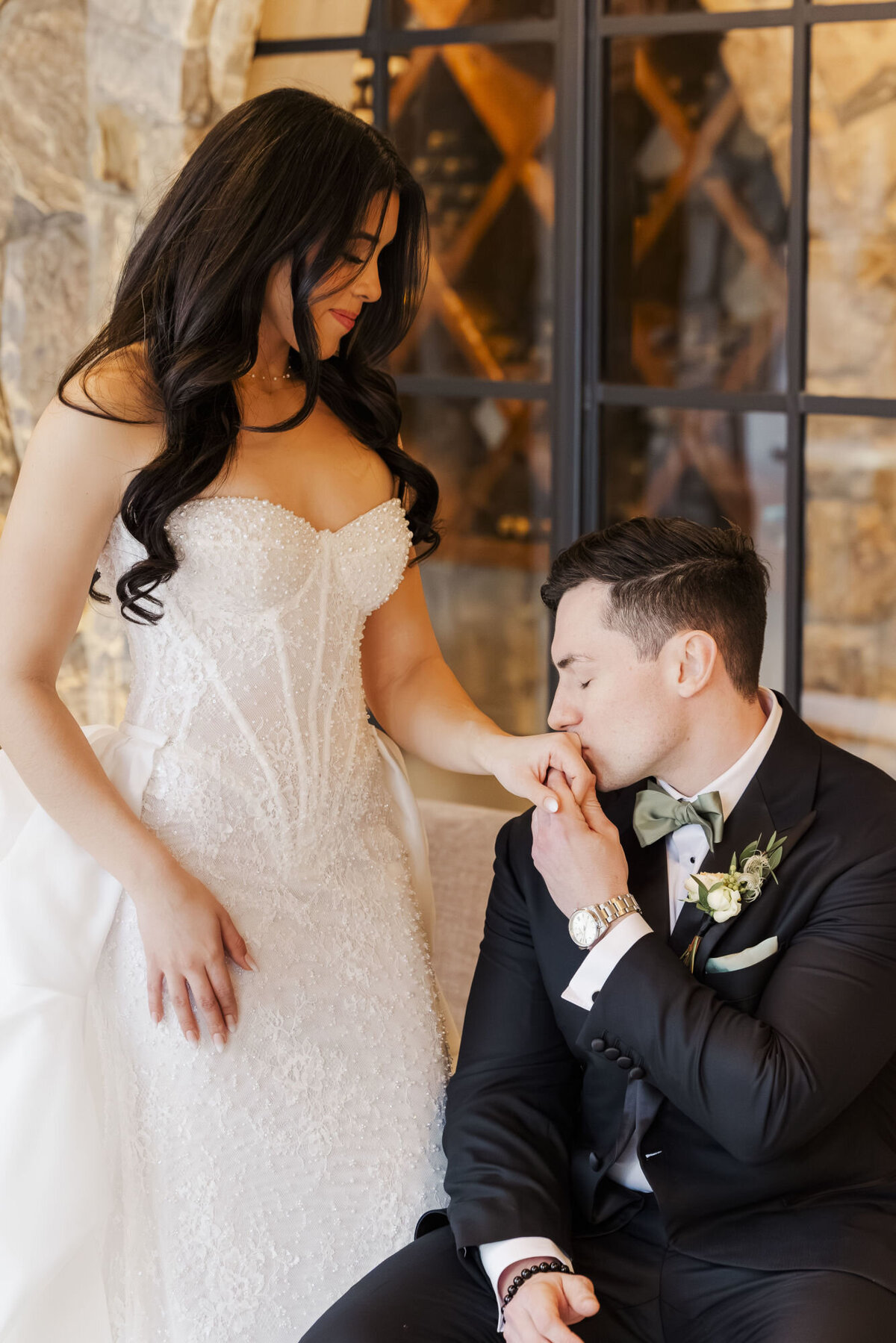 John kissing Shanna's hand during their wedding day portraits