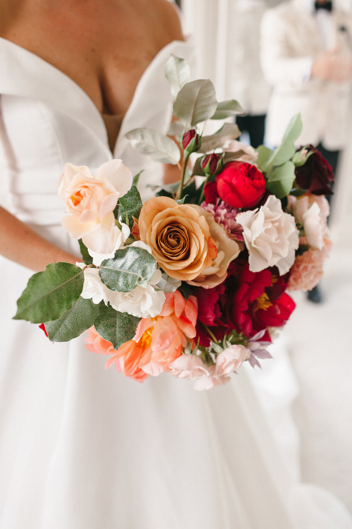 Red gold and blush Roses and peonies Bridal bouquet 