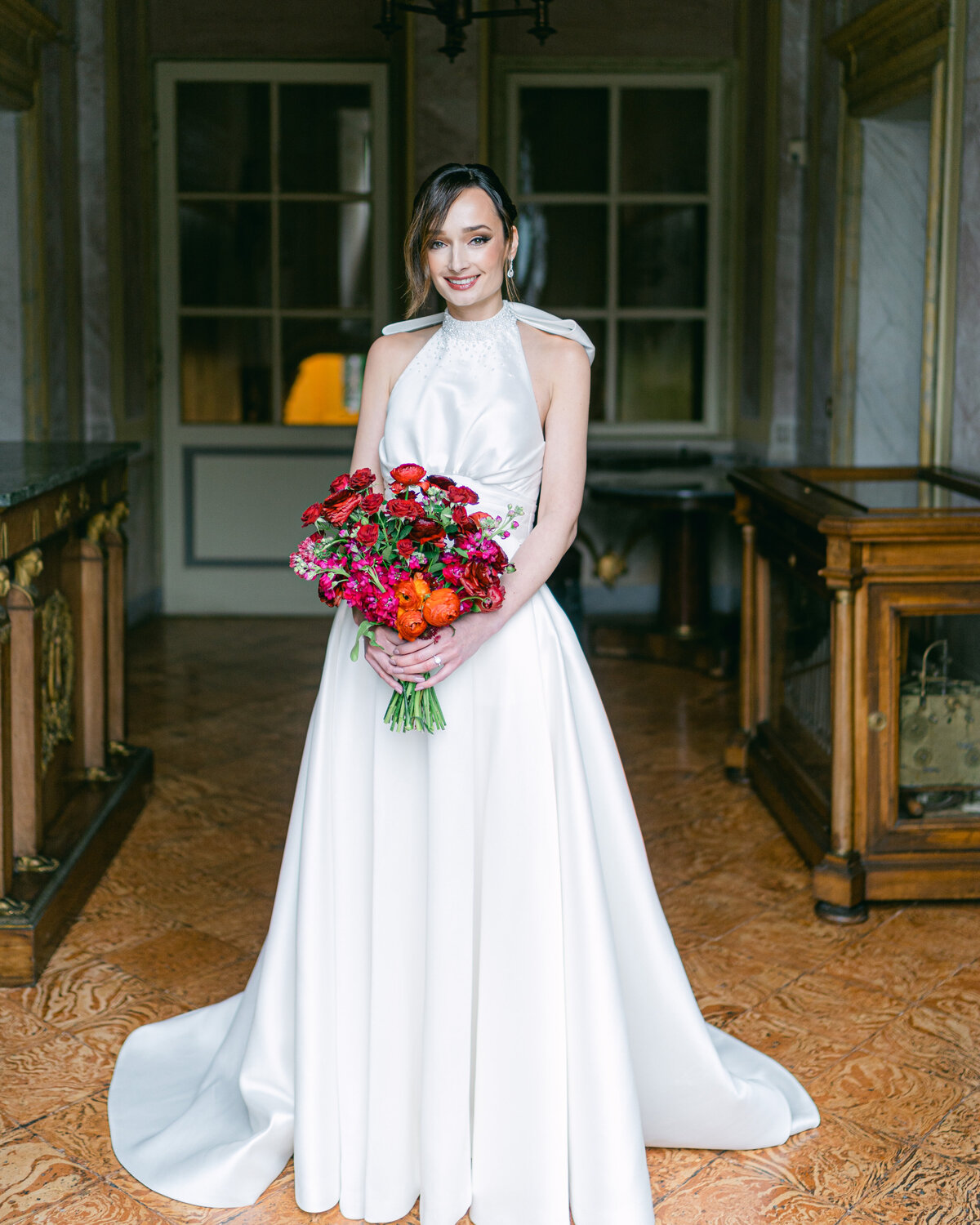 Bridal portrait in bespoke wedding dress with red bouquet at Villa Pizzo on Lake Como