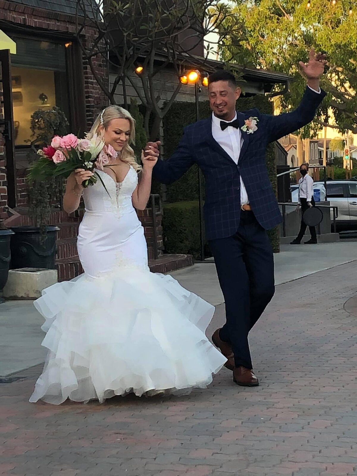 bride and groom raise their hands in celebration after ceremony
