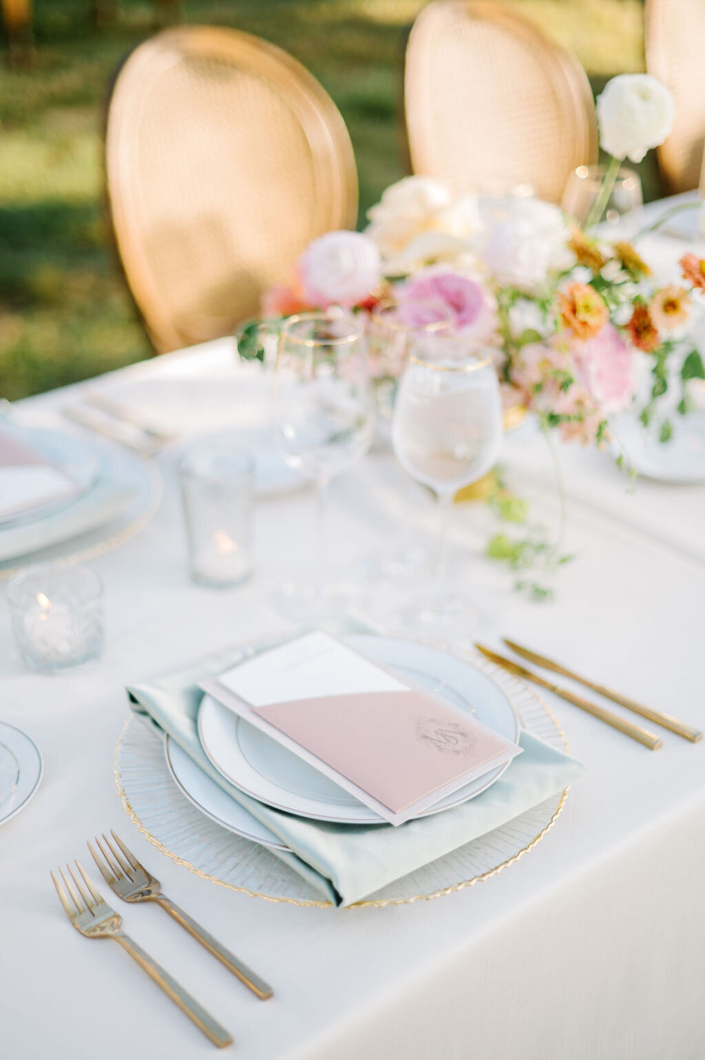 Wedding reception table that has dinnerwares and custom menu calligraphy