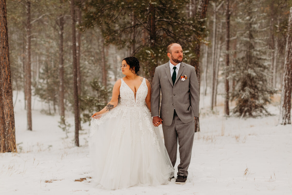 bride and groom in a snowy forest setting