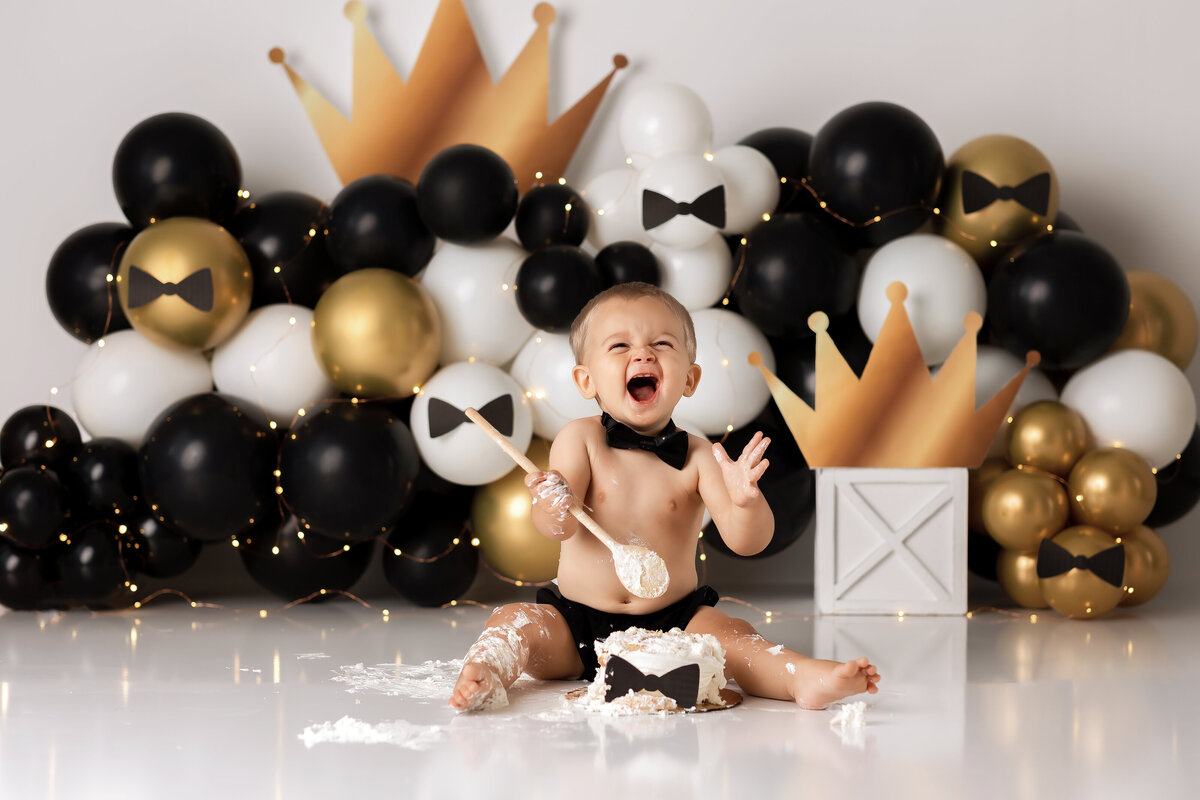 One year old Tampa baby enjoying a personalized luxury cake smash session with mister onederful decorations