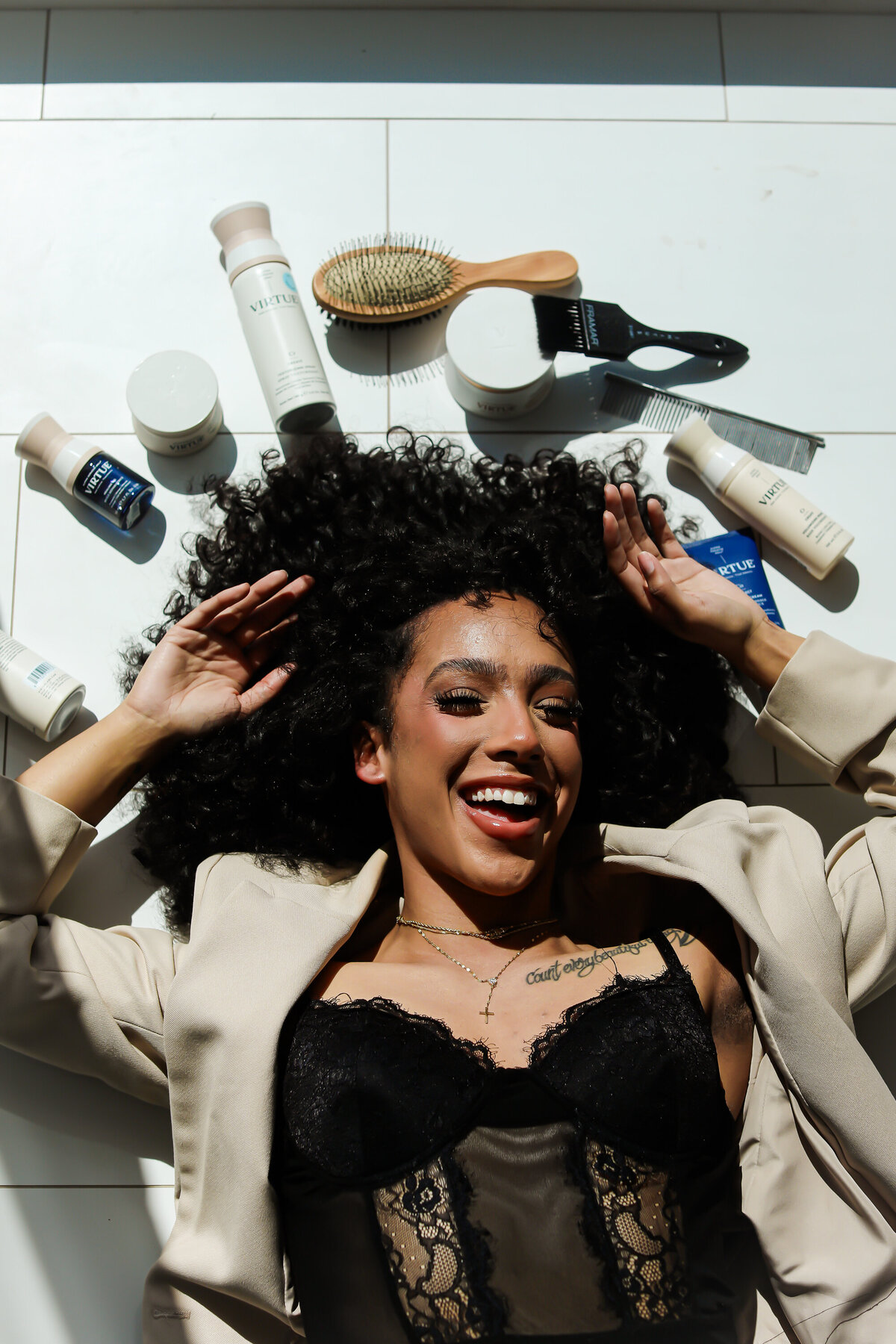 Model on floor with hair products
