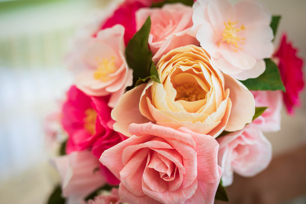 Rose and camellia details of pink wedding bouquet in paper