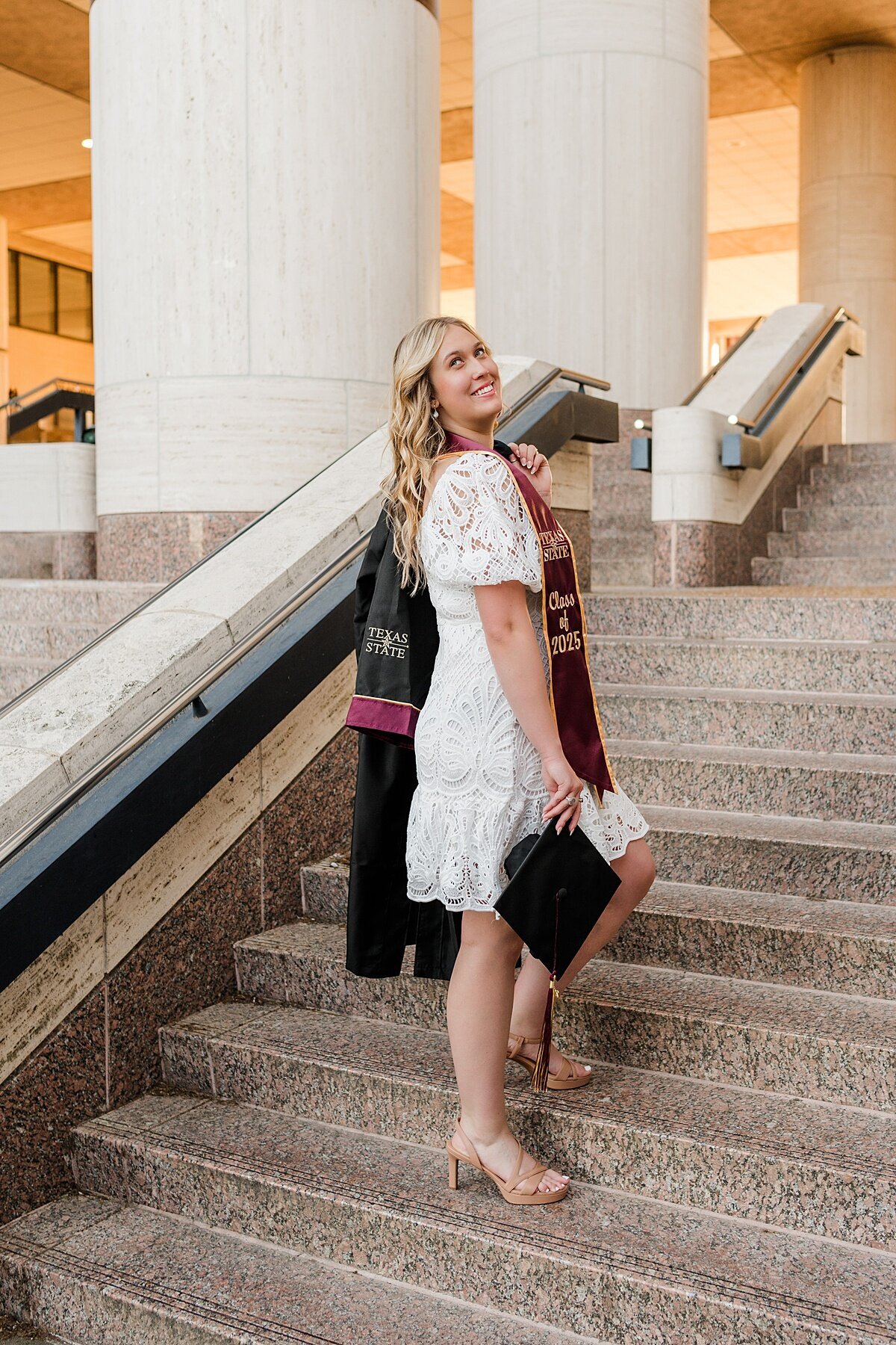 Texas State University grad girl walking at Alkek