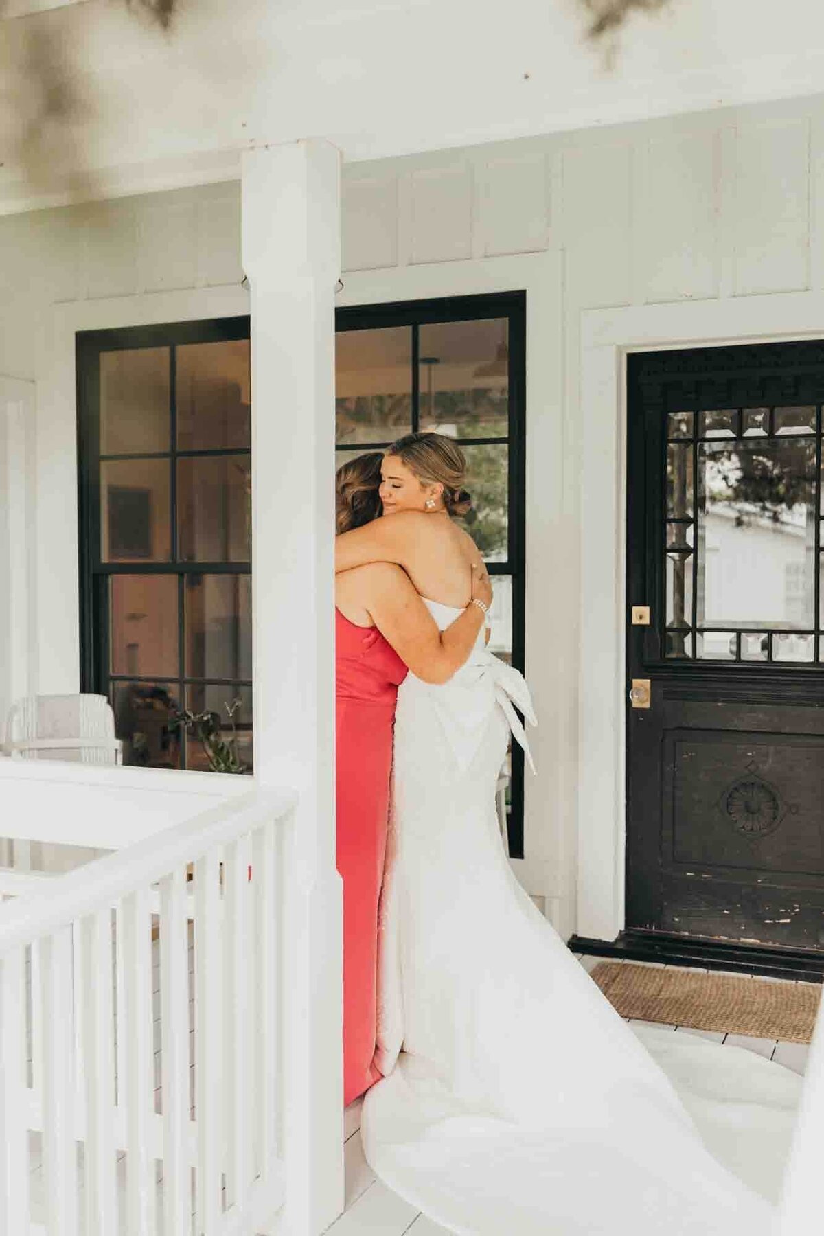 mother and daughter hug each other after mom sees her daughter in her wedding gown for the first time.