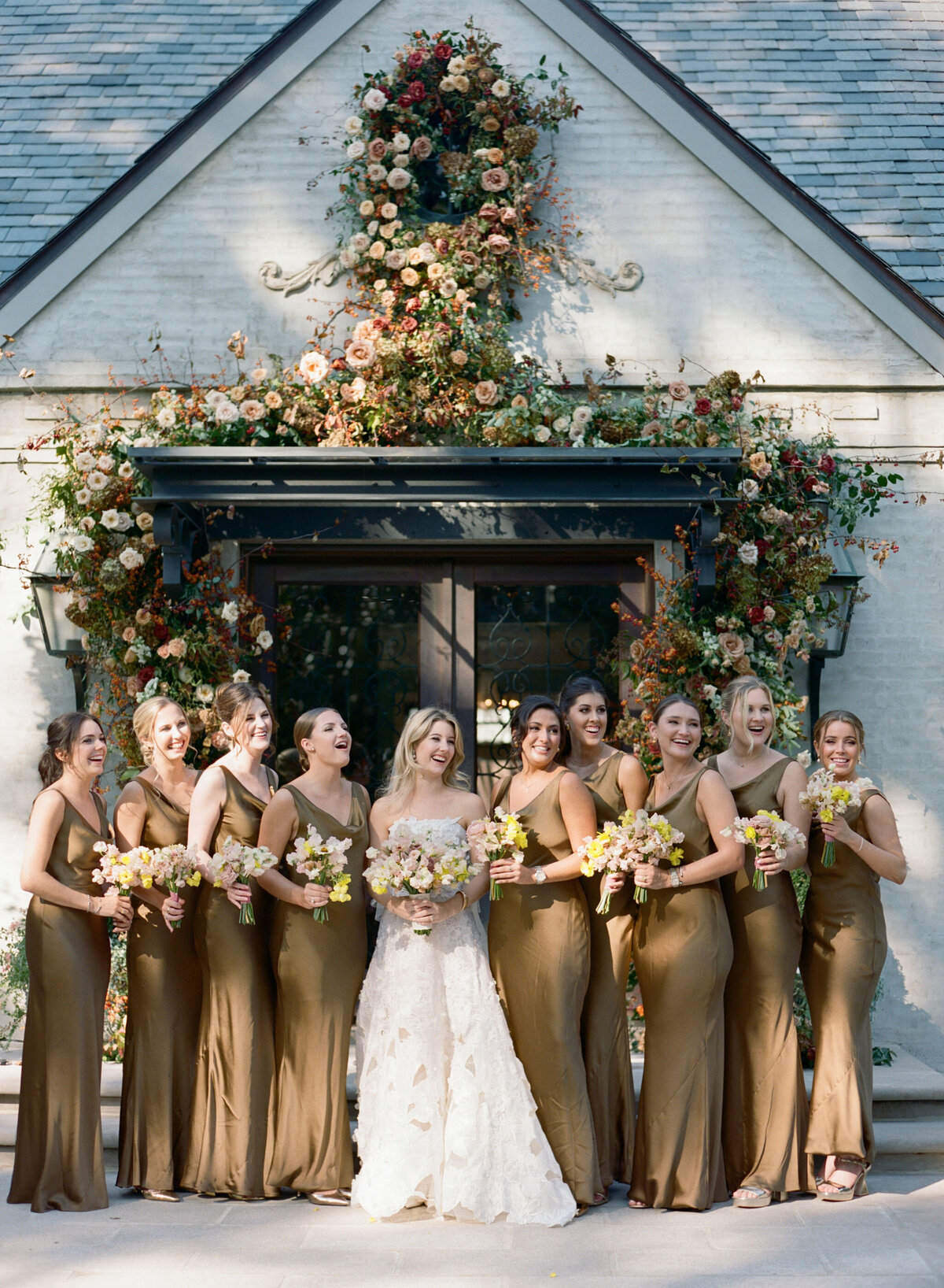 Organic growing floral installation for fall wedding ceremony backdrop. Private residence wedding build out for outdoor wedding ceremony and reception. Whimsical and organic floral design for autumnal wedding in colors of copper, yellow, blush, cream, and pops of orange. Clear tented wedding outside Nashville, TN. Design by Rosemary & Finch Floral Design in Nashville, TN.