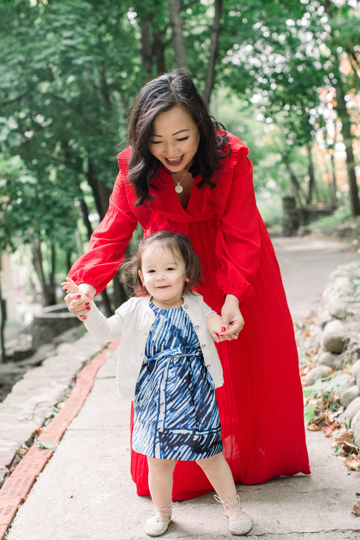 woman in red coat with child at new hampshire family photo session