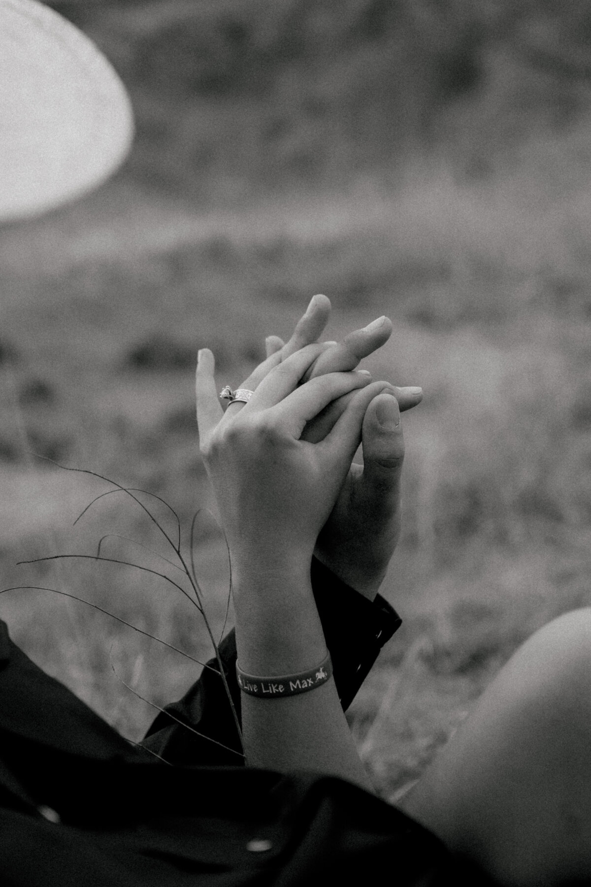 close up of couples hands showing her engagement ring