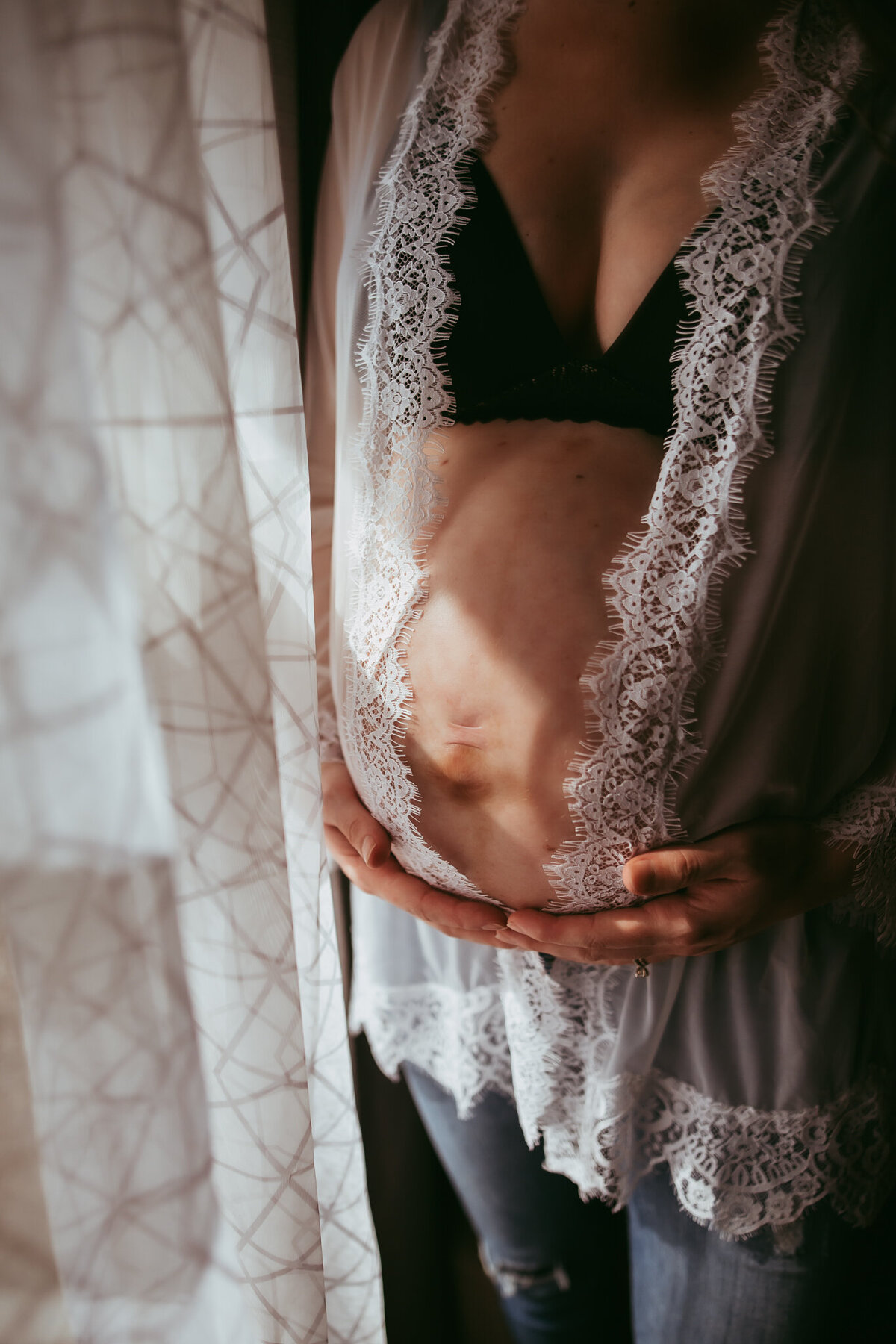 window light across pregnant belly