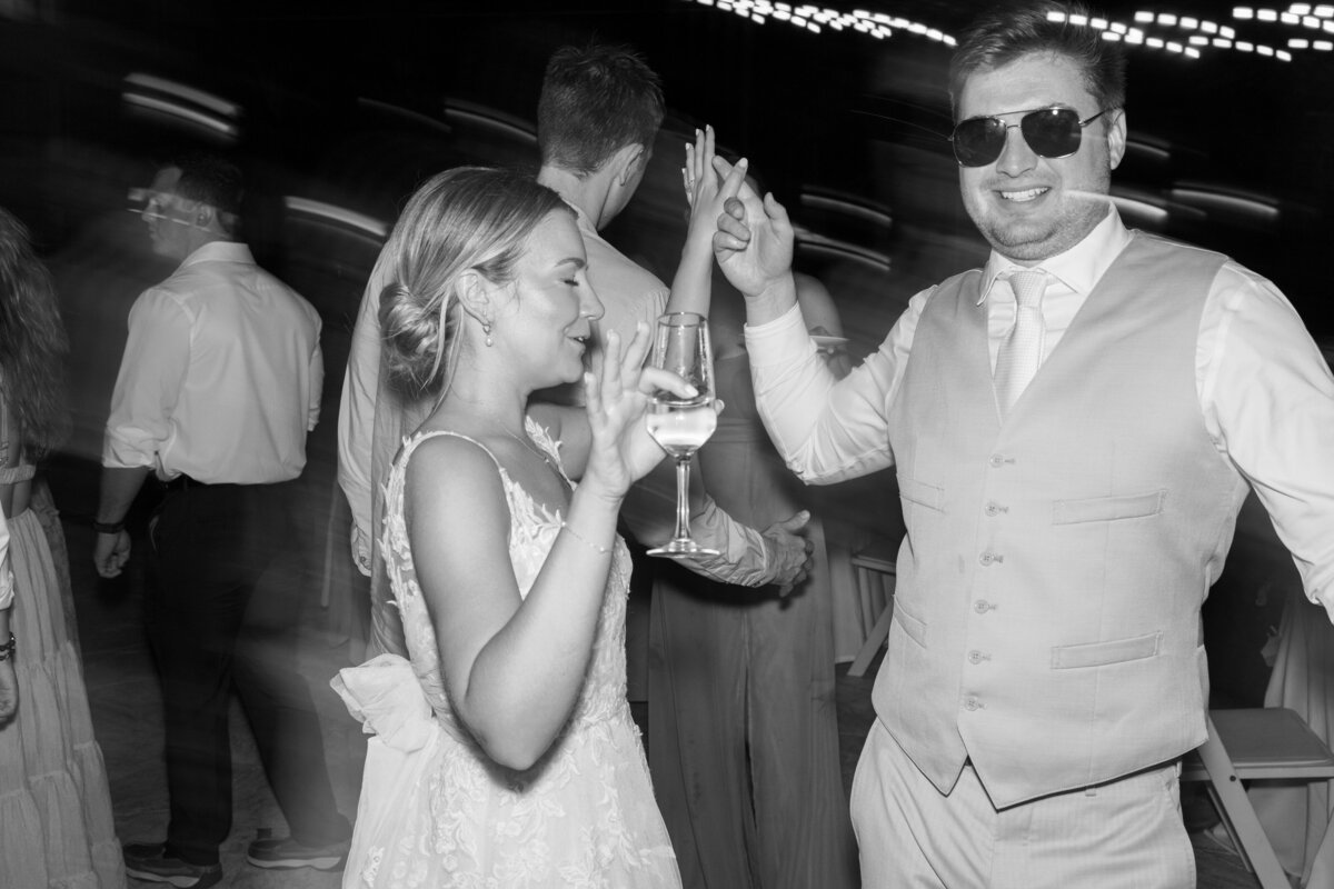 Bride and groom dancing under string lights at a Cancun wedding, captured by Philadelphia wedding photographer.