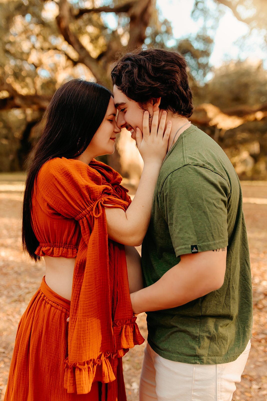 Spring TX maternity session—expecting couple standing close forehead to forehead