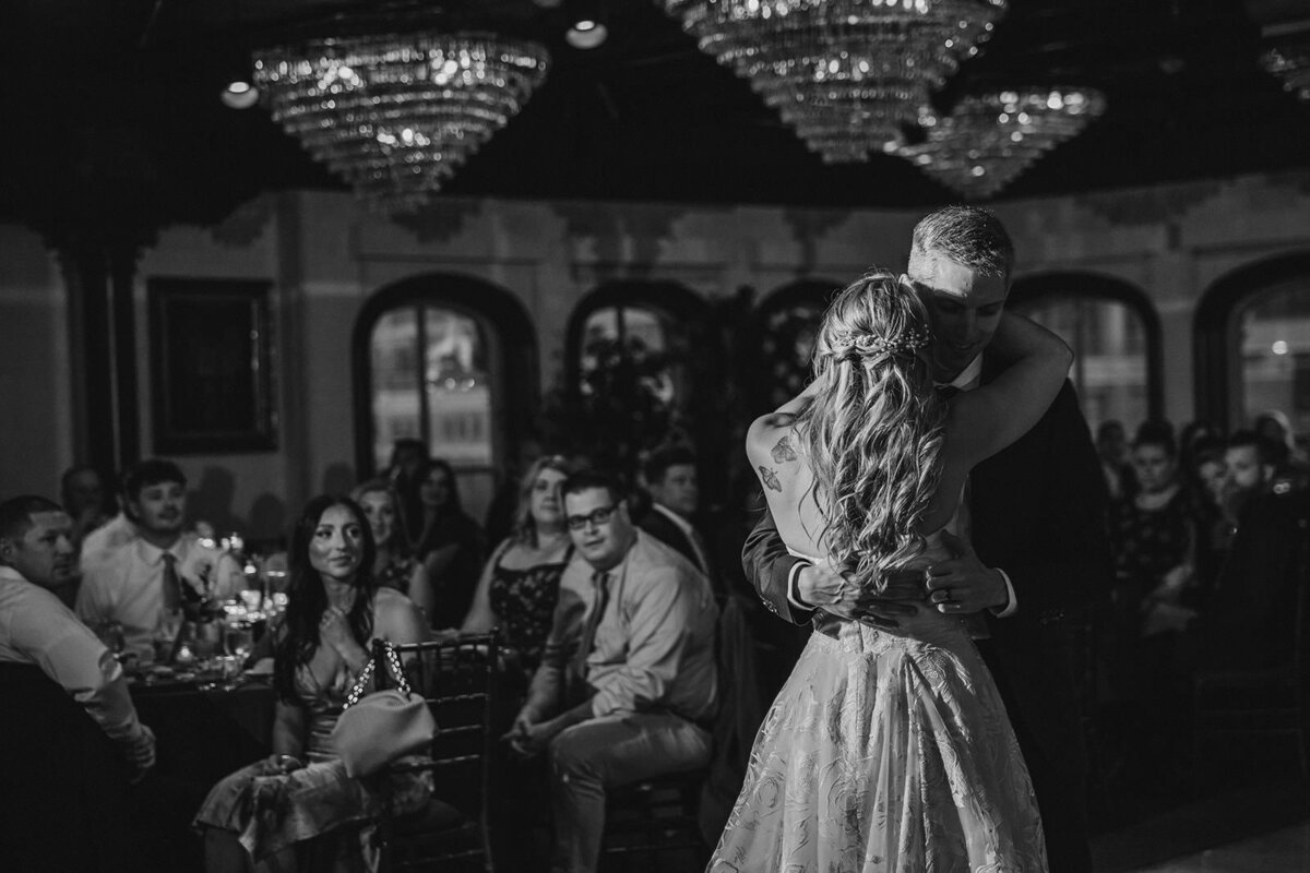 A parent dancing with their child at their wedding reception 