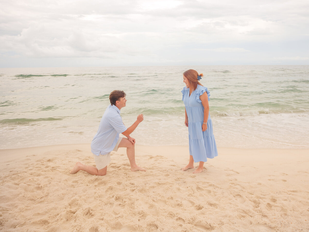 Proposal with man on knee holding ring for young  fiancee