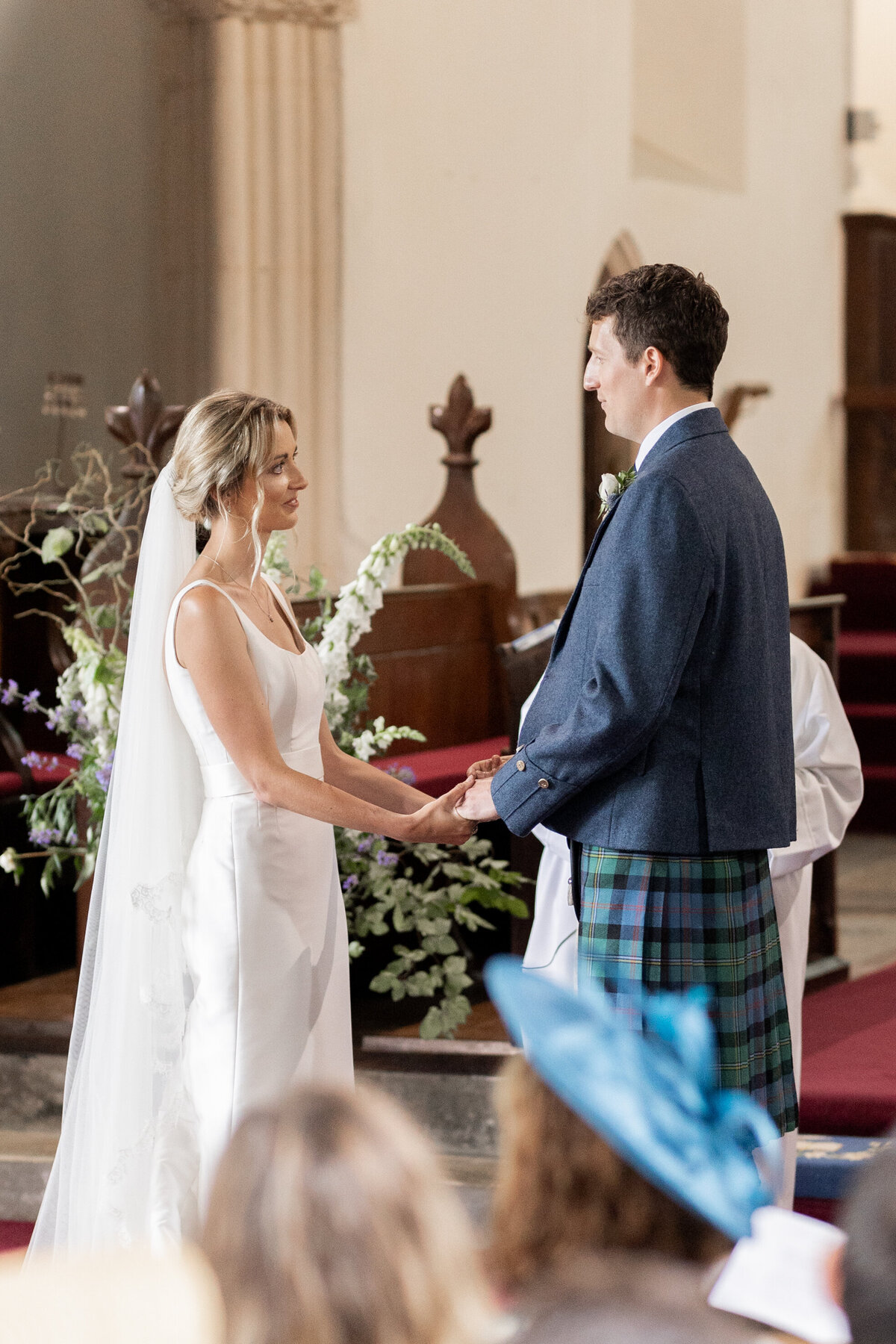 The bride and groom say their vows during their church wedding ceremony