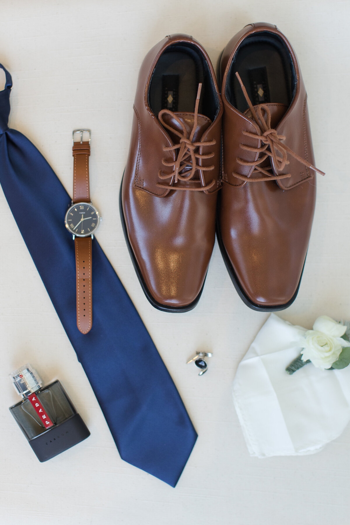 groom details brown shows blue tie brown watch and prada cologne