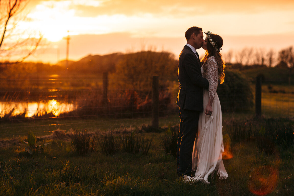 Golden hour portraits of wedding couple taken in a carpark at Milkyway wedding venue in North Devon