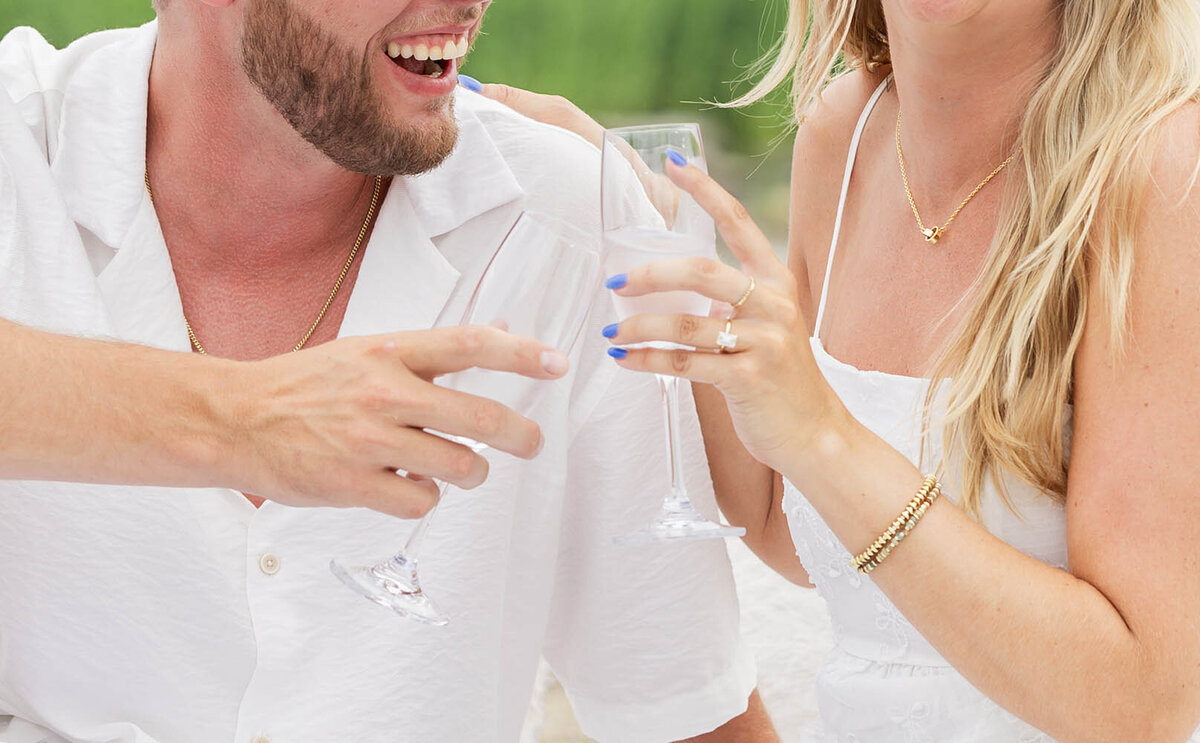 A man and woman toast cheers with each other  during a coastal Connecticut session